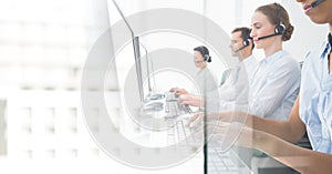 Customer service assistants with headsets with bright office background