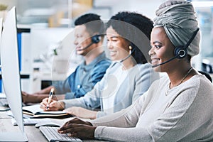 Customer service, call center and a team at computer with a headset for contact us website. Black woman and employees as