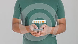 Customer service experience and business satisfaction survey concept. Close-up of man hand using smartphone with five-star popup