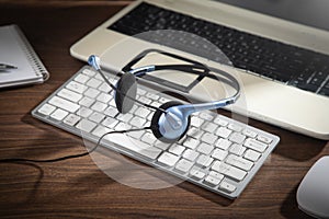 Customer service headset on the computer keyboard