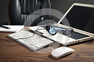 Customer service headset, computer keyboard and business objects on the table