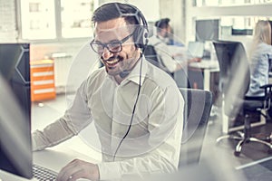 Customer service operator with headset talking with client in call center.