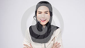 Customer service operator muslim woman in suit wearing headset over white background studio