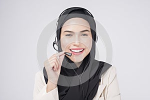 Customer service operator muslim woman in suit wearing headset over white background studio