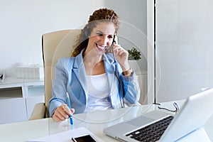 Customer service operator talking on phone in the office.