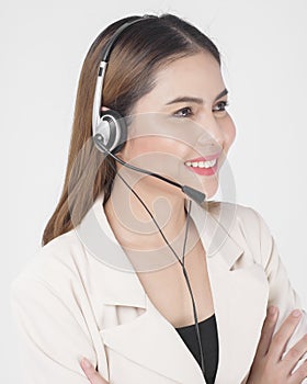 Customer service operator woman in suit wearing headset over white background studio