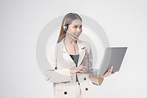 Customer service operator woman in suit wearing headset over white background studio