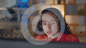 Customer service, remote work and a woman consultant talking on a headset in her home at night. Computer, call center