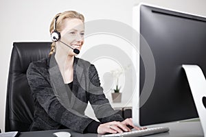 Customer Service Representative Typing on Computer