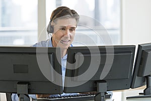 Customer Service Representative Using Multiple Screens photo