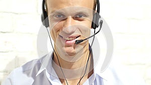 Customer service representative wearing a headset at the office , call center