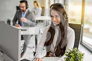 Customer service representative woman in headphones working at modern office.