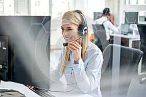 Customer service representative woman working on computer in office.