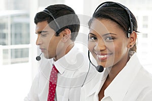 Customer service representatives at work in multiethnic call center photo