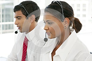 Customer service representatives at work in multiethnic call center photo