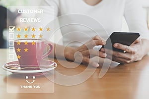 Customer service and Satisfaction concept ,Women hand hold smart phone empty screen choose the 5 star icon to give satisfaction in