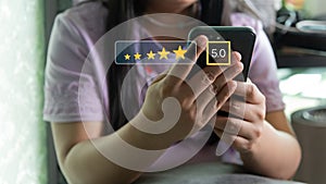 Customer service satisfaction evaluation concept. Man using smartphone and touching on screen with gold five star rating excellent
