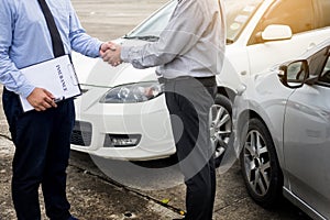 Customer shake hand with auto insurance agents after agreeing to