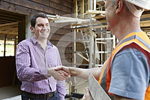 Customer Shaking Hands With Builder photo