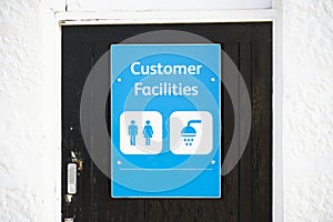 Customer shower facilities sign at public toilet