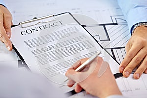 Customer signing contract document at office