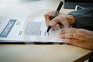 Customer signing a paper document for rental or buy a home - Real Estate Concept