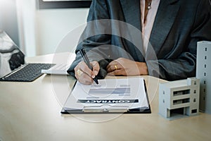 Customer signing a paper document for rental or buy a home - Real Estate Concept