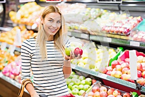 Customer at supermarket front of fruits shelf