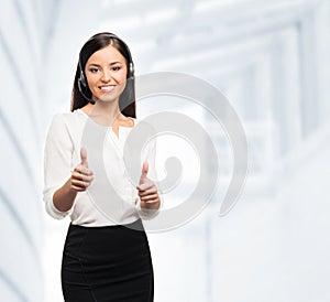 A customer support operator holding thumbs up