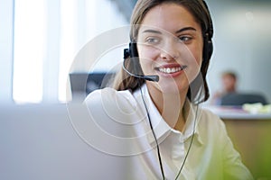 Customer support operator working in a call center office.