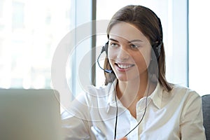 Customer support operator working in a call center office. photo