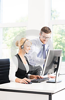 Customer support operators in formalwear working in a call center