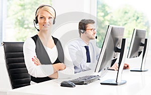 Customer support operators in formalwear working using computers