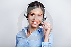 Customer support phone operator in headset, with blank copyspace area for slogan or text message, over grey background