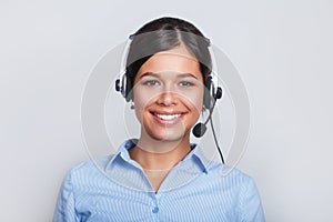 Customer support phone operator in headset, with blank copyspace area for slogan or text message, over grey background