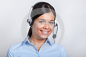 Customer support phone operator in headset, with blank copyspace area for slogan or text message, over grey background