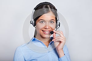 Customer support phone operator in headset, with blank copyspace area for slogan or text message, over grey background