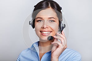 Customer support phone operator in headset, with blank copyspace area for slogan or text message, over grey background