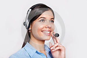 Customer support phone operator in headset, with blank copyspace area for slogan or text message, over grey background