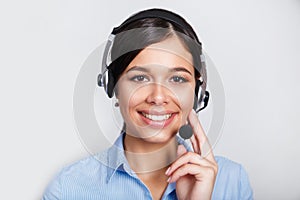 Customer support phone operator in headset, with blank copyspace area for slogan or text message, over grey background
