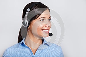 Customer support phone operator in headset, with blank copyspace area for slogan or text message, over grey background