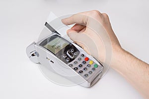 Customer is swiping magnetic credit card in payment terminal