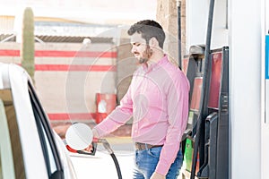 Customer Tanking Car At Gas Station