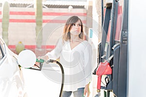 Customer Tanking Car At Self-Service Gas Station