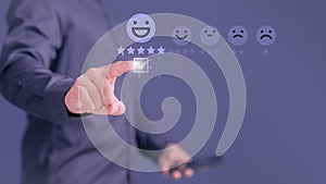 Customer touching the virtual screen on the smile face icon and five stars to give satisfaction in service.