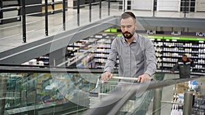 A customer with a trolley on escalator in a construction store