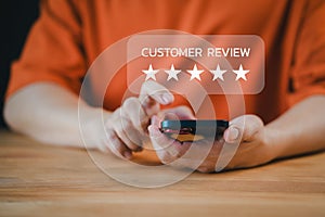 Customer use a smartphone give point with virtual screen on five stars icon for satisfaction in opinion and service. Customer