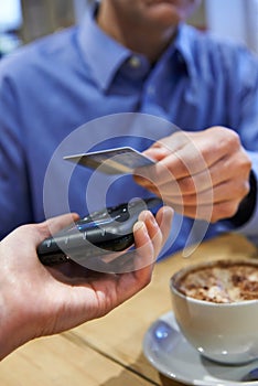 Customer Using Contactless Payment In Coffee Shop