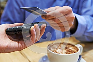 Customer Using Contactless Payment In Coffee Shop