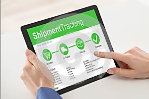 Customer Using Digital Tablet With Shipment Tracking Website